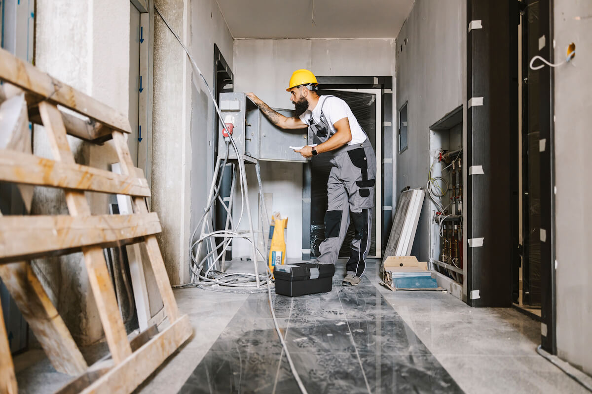 Electrician fixing electricity in building site