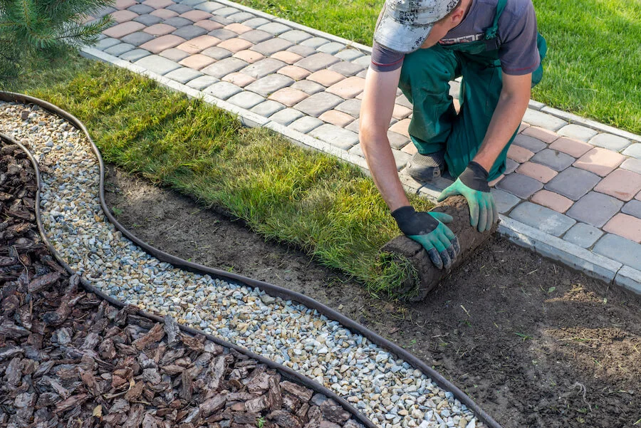 Gardener laying turf