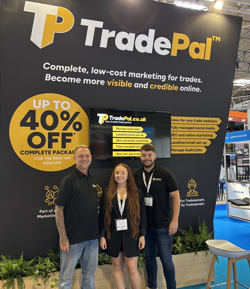 Martyn, Grace and Ross from TradePal stand smiling in front of their InstallerSHOW 2025 marketing display.
